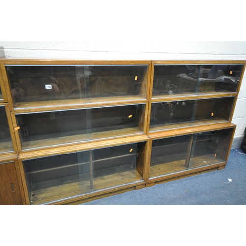 1285 - FOUR MID CENTURY MINTY TEAK SECTIONAL BOOKCASE, to include four bases, with twelve sections in total... 