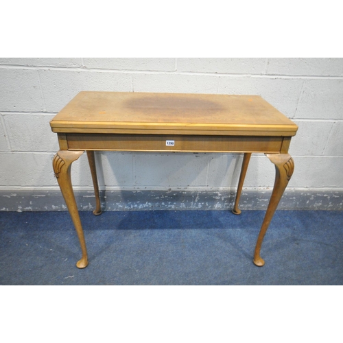 1290 - A REPRODUCTION WALNUT CARD TABLE, with a fold over top enclosing a playing surface, along with a pla... 