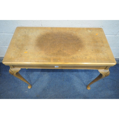 1290 - A REPRODUCTION WALNUT CARD TABLE, with a fold over top enclosing a playing surface, along with a pla... 