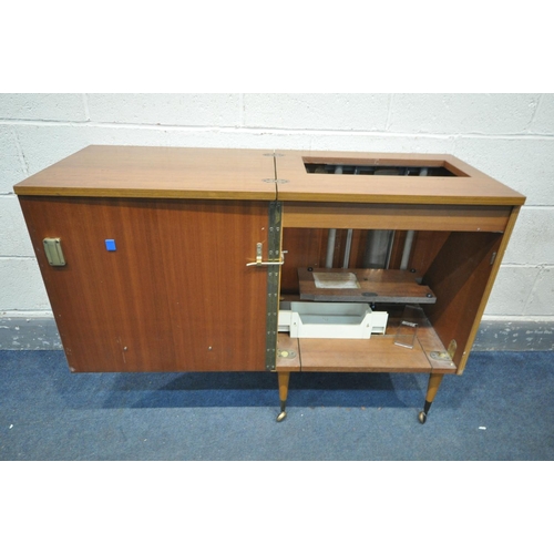 1298 - A MID CENTURY TEAK SEWING CABINET. with a fold over top and single door, enclosing a rise and fall m... 