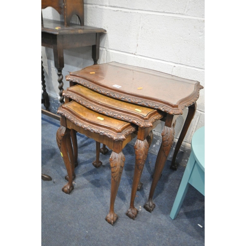 1299 - A 20TH CENTURY BURR WALNUT SERPENTINE NEST OF THREE TABLES, with glass inserts, largest length 60cm ... 