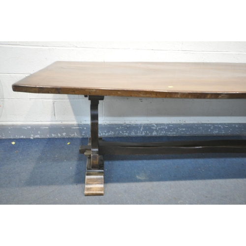 1302 - A REPRODUCTION OAK REFRECTORY TABLE, on a shaped trestle base united by two stretchers, length 261cm... 