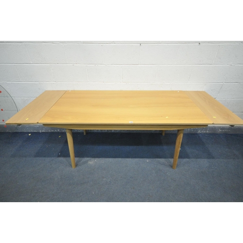 1304 - A JOHN LEWIS LIGHT OAK DINING TABLE, with two additional leaves/drawers, on cylindrical tapered legs... 