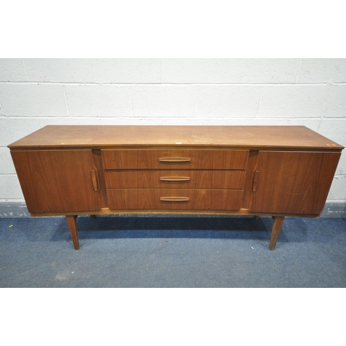 1307 - A MID CENTURY TEAK BEAUTILITY CONCAVE SIDEBOARD, with two cupboard doors, flanking three graduated d... 