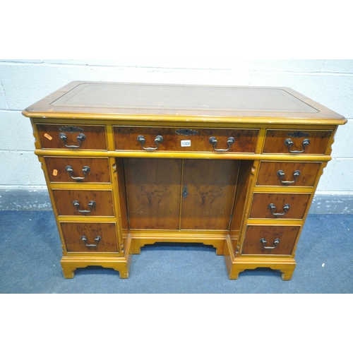 1324 - A YEW WOOD WRITING DESK, with tanned tooled leather inlay, canted corners, nine assorted drawers, su... 