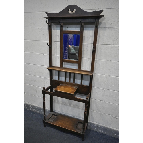 1350 - AN EDWARDIAN OAK HALL STAND, with six hooks flanking a bevelled mirror, width 76cm x depth 28cm x 20... 