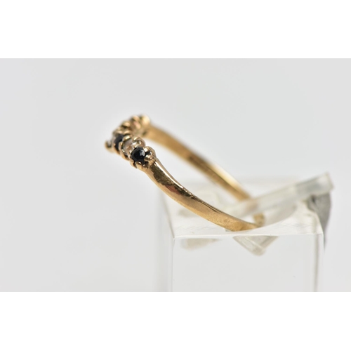 11 - A 9CT GOLD GEM SET WISH BONE RING, designed with a row of four claw set, circular cut sapphires inte... 