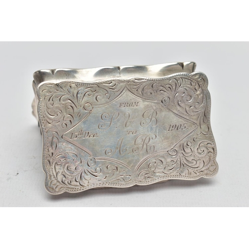 110 - AN EDWARDIAN SILVER TABLE SNUFF BOX, the undulating rectangular box with hinged lid, scrolling folit... 