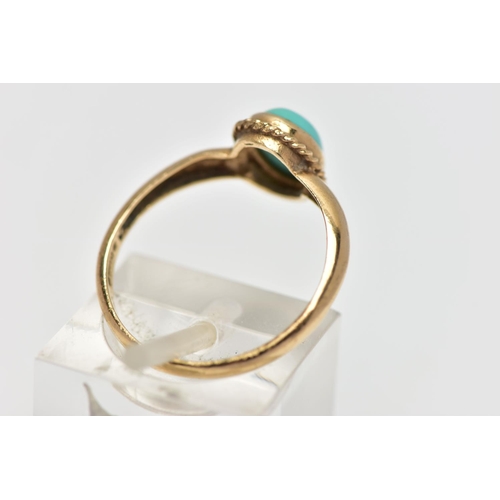 123 - A 9CT GOLD TURQUOISE RING, designed with an oval turquoise cabochon, collet set with a fine rope twi... 