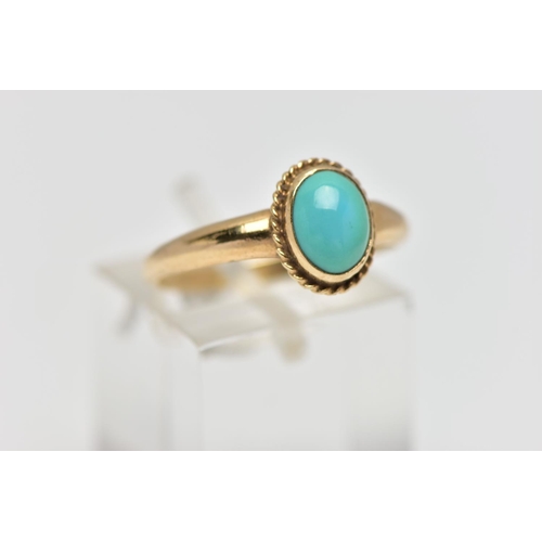 123 - A 9CT GOLD TURQUOISE RING, designed with an oval turquoise cabochon, collet set with a fine rope twi... 