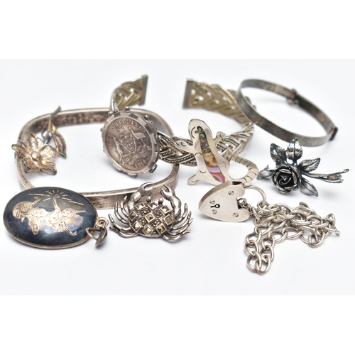 129 - AN ASSORTMENT OF WHITE METAL JEWELLERY, to include a square bangle, a damascene pendant, a heart pad... 