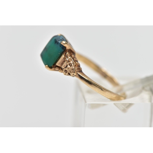 13 - A YELLOW METAL TURQUOISE RING, rectangular blue/green turquoise cabochon, four claw set in a raised ... 