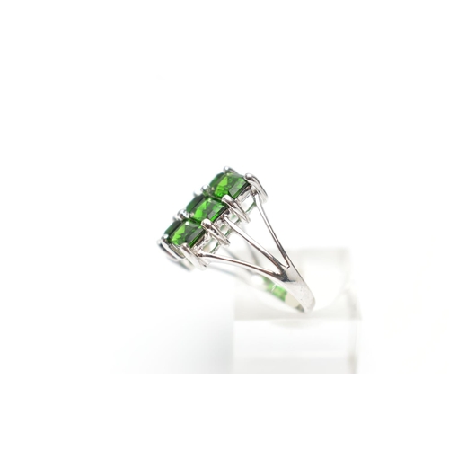 135 - A 9CT WHITE GOLD CHROME DIOPSIDE DRESS RING, comprising nine rectangular cut chrome diopside, each w... 