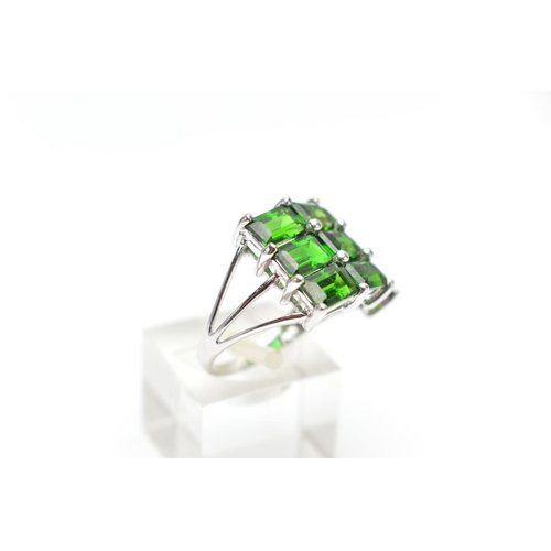 135 - A 9CT WHITE GOLD CHROME DIOPSIDE DRESS RING, comprising nine rectangular cut chrome diopside, each w... 