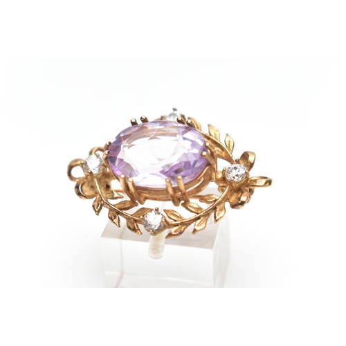 137 - A MID 20TH CENTURY 9CT GOLD AMETHYST AND CUBIC ZIRCONIA BROOCH, the oval claw set amethyst, within a... 