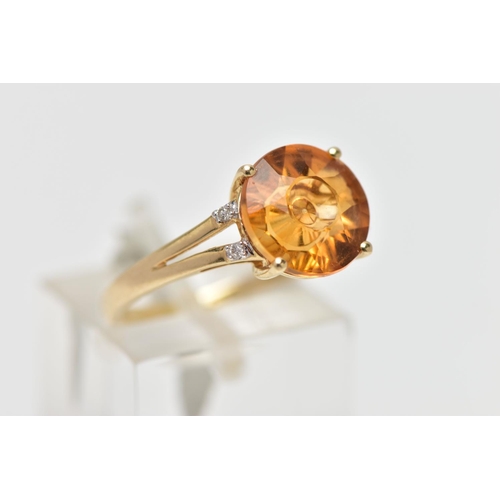 14 - A 9CT GOLD GEM SET RING, four claw set, fancy circular cut orange stone assessed as citrine, bifurca... 