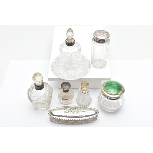 155 - ASSORTED GLASS VANITY JARS, of various shapes, such as an elongated oval jar with an embossed cherub... 