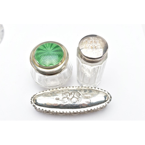 155 - ASSORTED GLASS VANITY JARS, of various shapes, such as an elongated oval jar with an embossed cherub... 