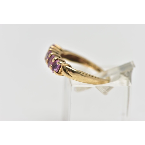 16 - A 9CT GOLD FIVE STONE RING, designed with a row of four claw set, oval cut pink stones assessed as s... 