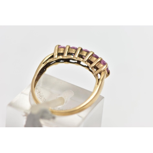 16 - A 9CT GOLD FIVE STONE RING, designed with a row of four claw set, oval cut pink stones assessed as s... 