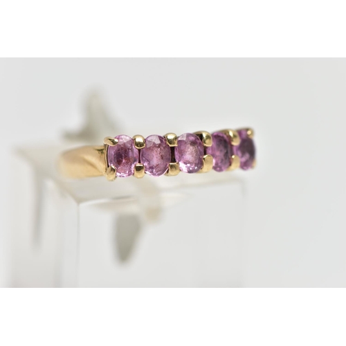 16 - A 9CT GOLD FIVE STONE RING, designed with a row of four claw set, oval cut pink stones assessed as s... 