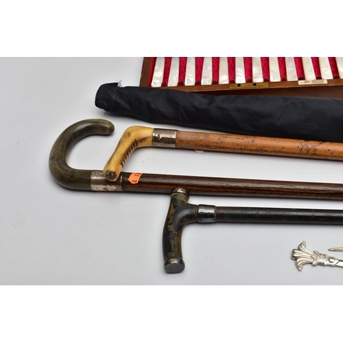 181 - THREE WALKING STICKS, AN UMBRELLA AND OTHER ITEMS, to include a light wooden walking stick fitted wi... 