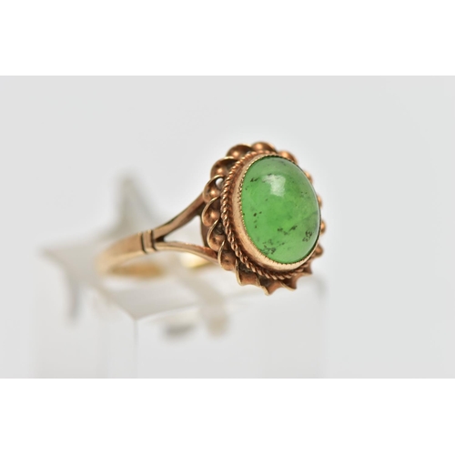 25 - A 9CT GOLD CHRYSOPRASE SINGLE STONE RING, the oval chrysoprase cabochon collet set with rope twist s... 