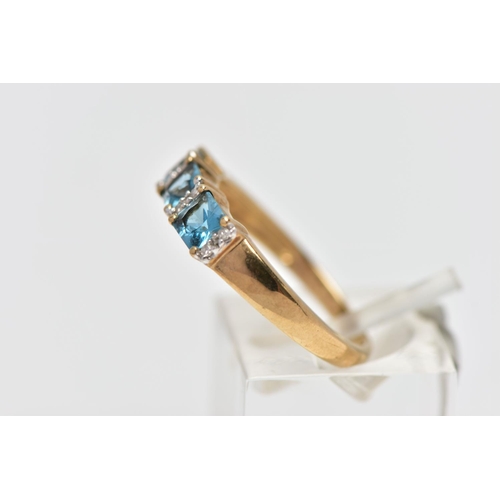 29 - A 9CT GOLD TOPAZ AND DIAMOND DRESS RING, the cushion cut blue topaz with single cut diamond duo spac... 