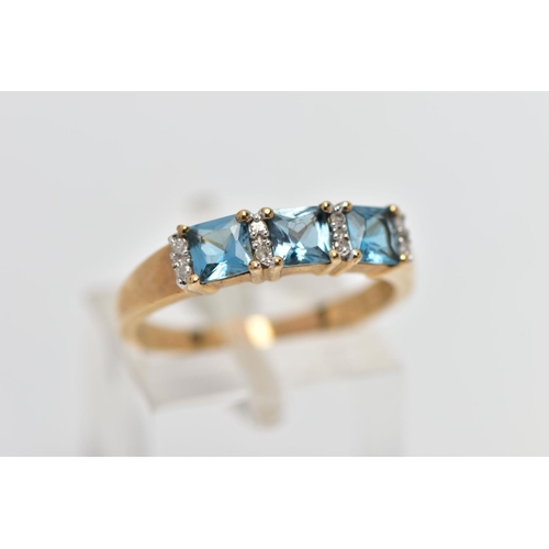 29 - A 9CT GOLD TOPAZ AND DIAMOND DRESS RING, the cushion cut blue topaz with single cut diamond duo spac... 