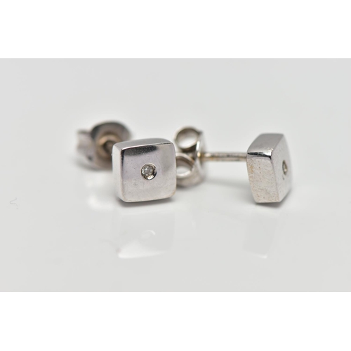 59 - A PAIR OF WHITE METAL DIAMOND EARRINGS, the circular cut diamonds each set within a recess, to the s... 