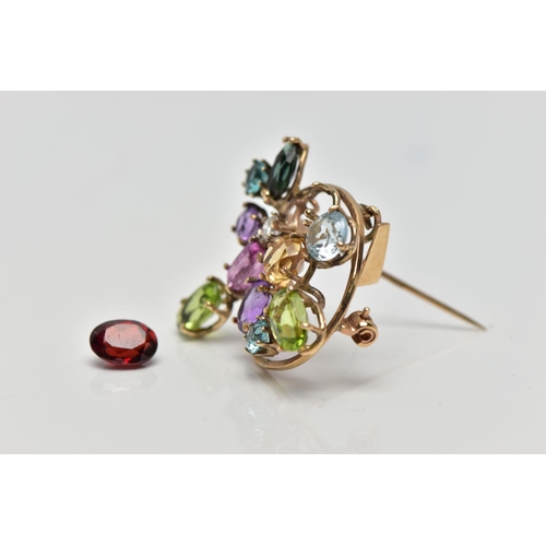 62 - A 9CT GOLD DIAMOND AND COLOURED GEM SET BROOCH, of openwork design the circular cut diamond, estimat... 