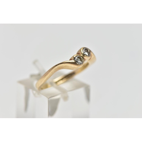 63 - A 9CT YELLOW GOLD DIAMOND TWO STONE CROSSOVER RING, set with two round brilliant cut diamonds, each ... 