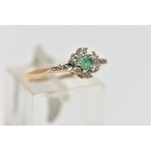 66 - A 9CT GOLD EMERALD AND DIAMOND CLUSTER RING, set with a circular cut emerald, within a round brillia... 