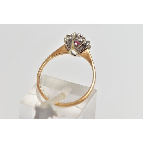 69 - A 9CT YELLOW AND WHITE GOLD RUBY AND DIAMOND CLUSTER RING, set with a marquise shape ruby, within a ... 