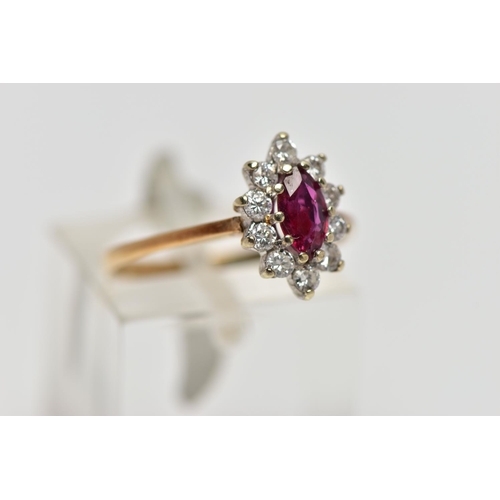 69 - A 9CT YELLOW AND WHITE GOLD RUBY AND DIAMOND CLUSTER RING, set with a marquise shape ruby, within a ... 