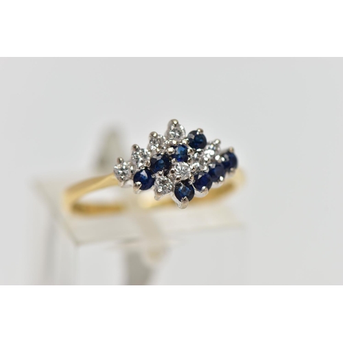 70 - AN 18CT YELLOW AND WHITE GOLD SAPPHIRE AND DIAMOND DRESS RING, the marquise shape tiered cluster set... 