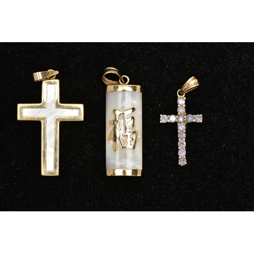 75 - THREE YELLOW METAL PENDANTS, to include a 9ct gold tanzanite cross, hallmarked 9ct Sheffield, a moth... 