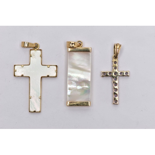 75 - THREE YELLOW METAL PENDANTS, to include a 9ct gold tanzanite cross, hallmarked 9ct Sheffield, a moth... 