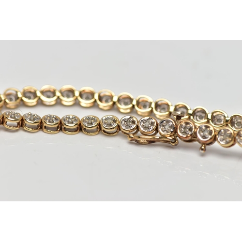 76 - A 9CT YELLOW GOLD DIAMOND LINE BRACELET, set with approximately fifty one single cut diamonds, each ... 