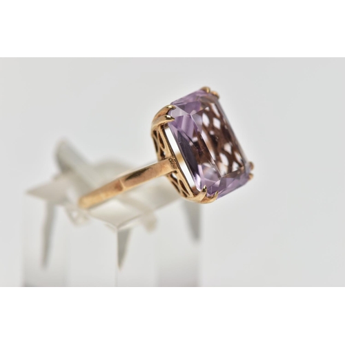 77 - A 9CT GOLD AMETHYST SINGLE STONE RING, the rectangular shape amethyst measuring approximately 14mm x... 