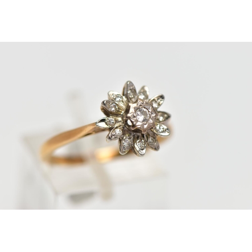 85 - AN 18CT GOLD DIAMOND FLORAL CLUSTER RING, the central brilliant cut diamond, claw set, to the single... 