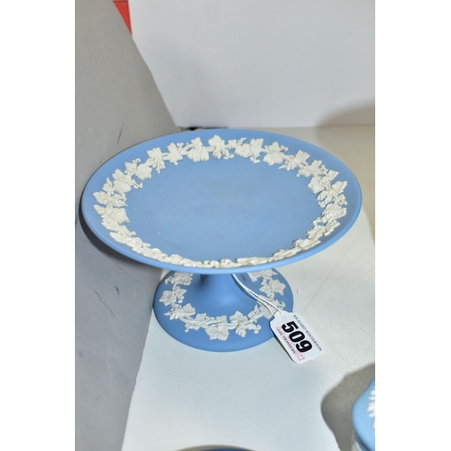 509 - SIX PIECES OF WEDGWOOD PALE AND DARK BLUE JASPERWARE, comprising a small comport, diameter 15.5cm, t... 