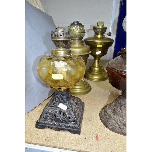 519 - A GROUP OF OIL LAMP BASES, ELECTRIC TABLE LAMP AND BRASS JAM PAN, comprising two brass oil lamp base... 