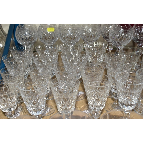 522 - A QUANTITY OF CUT CRYSTAL AND COLOURED GLASS, comprising a set of eleven long stemmed wine glasses, ... 