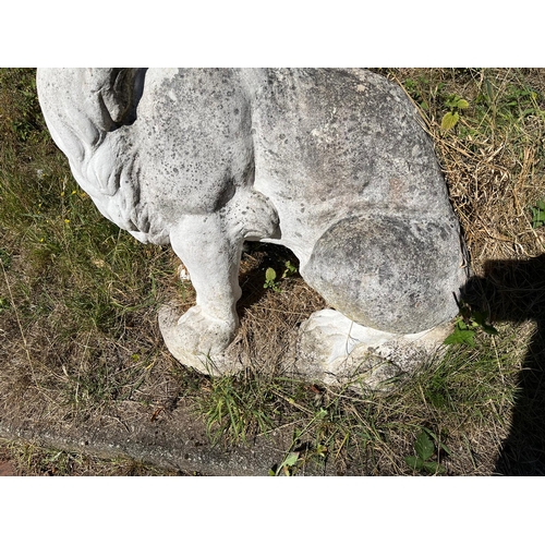 1045 - AN OPPOSING PAIR OF COMPOSITE SITTING LION GARDEN FIGURES on oval bases 160cm long and 46cm wide tot... 