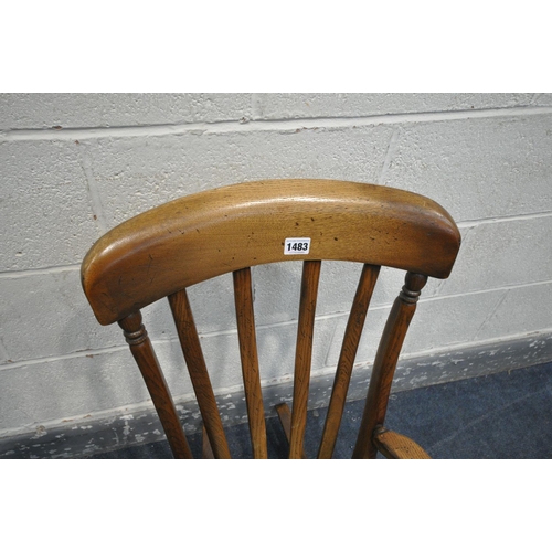 1483 - A REPRODUCTION OAK CHILDS ROCKING CHAIR, with a later fabric seat pad, width 41cm x depth 67cm x hei... 