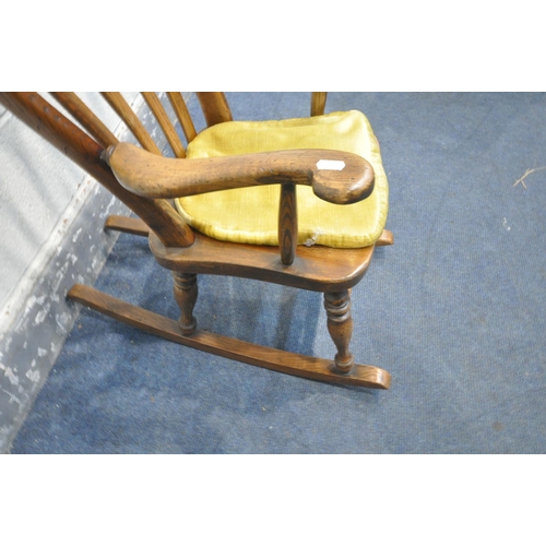 1483 - A REPRODUCTION OAK CHILDS ROCKING CHAIR, with a later fabric seat pad, width 41cm x depth 67cm x hei... 