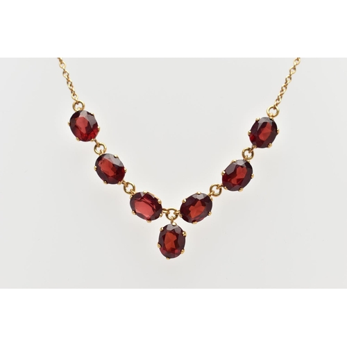 112 - A YELLOW METAL RED PASTE NECKLACE, comprising a series of oval cut red pastes, with a similarly cut ... 