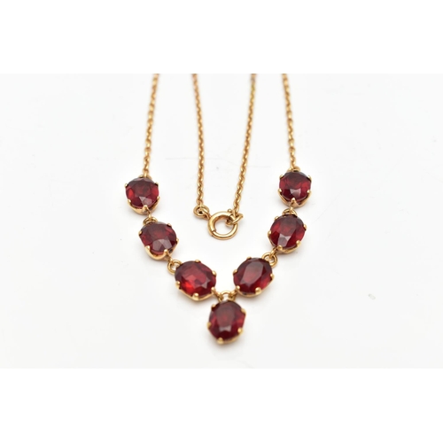 112 - A YELLOW METAL RED PASTE NECKLACE, comprising a series of oval cut red pastes, with a similarly cut ... 