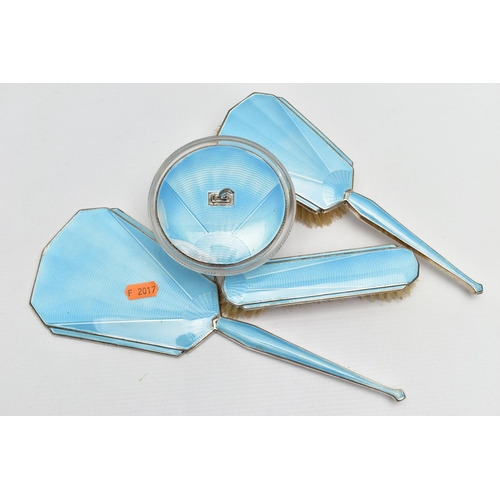 134 - A FOUR PIECE SILVER GUILLOCHE ENAMEL VANITY SET, comprising of a hair brush, clothes brush, hand hel... 